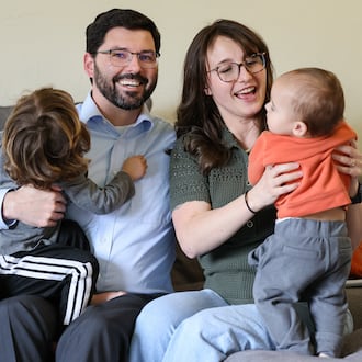 Kettering parent Katey Gibbins-Burdette (left) and her husband, Brandon Burdette, spend thousands of dollars per month on childcare for the couple's two children, age three years and 11 months. Childcare is increasingly unaffordable for young families. Changes to how Ohio pays childcare centers and a looming fiscal cliff for Ohio childcare could make it even more out of reach. BRYANT BILLING / STAFF