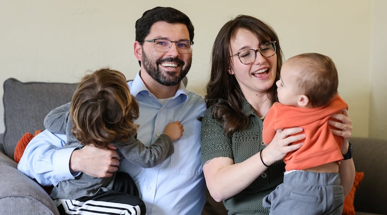 Kettering parent Katey Gibbins-Burdette (left) and her husband, Brandon Burdette, spend thousands of dollars per month on childcare for the couple's two children, age three years and 11 months. Childcare is increasingly unaffordable for young families. Changes to how Ohio pays childcare centers and a looming fiscal cliff for Ohio childcare could make it even more out of reach. BRYANT BILLING / STAFF
