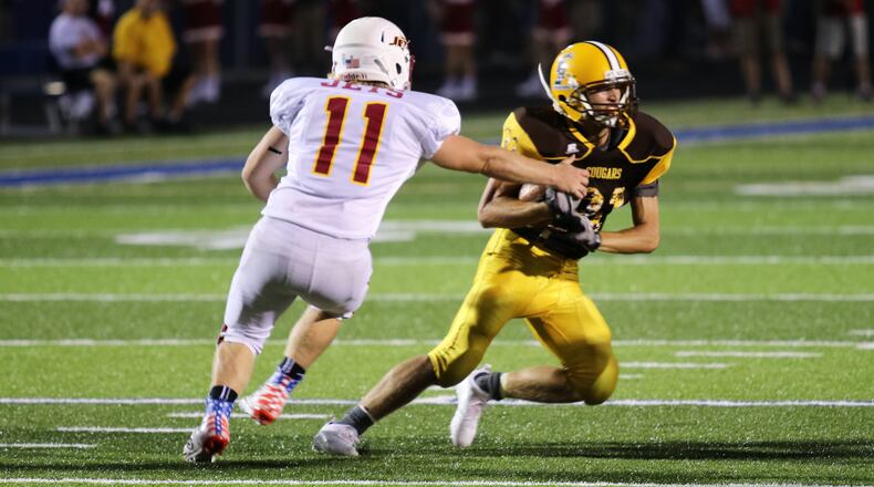 Northeastern High School senior Grant Hodson strips the ball from Kenton Ridge junior Carson Jones during a jamboree game on Friday, Aug. 17, at Evans Stadium in Springfield. MICHAEL COOPER/CONTRIBUTED