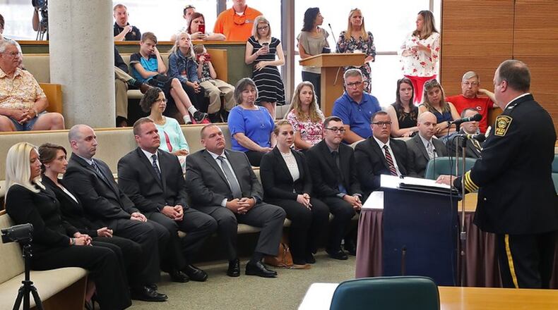 Springfield Police Chief Lee Graf addresses the city s newest 11 officers, seated in the front row, that were sworn in at the City Hall Forum. Bill Lackey/Staff