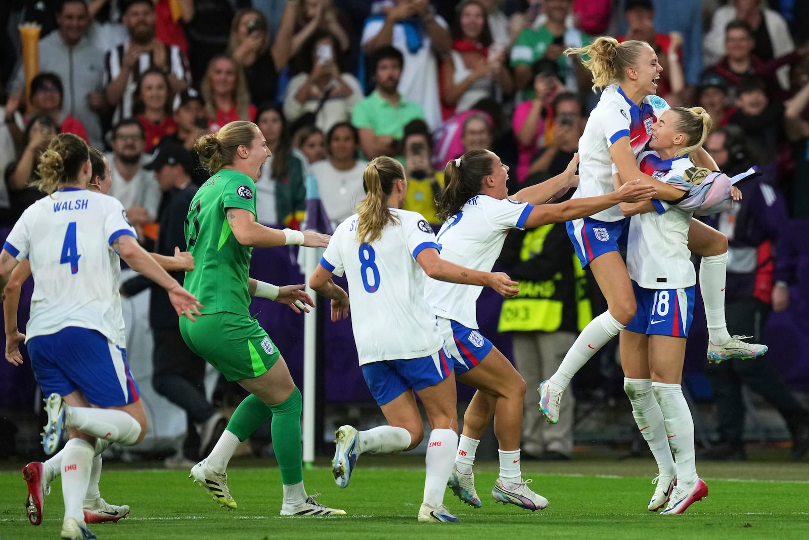 England players celebrate after England's Chloe Kelly, right, scored the decisive penalty in a penalty shootout at the end of the Women's Euro 2025 final soccer match between England and Spain at St. Jakob-Park in Basel, Switzerland, Sunday, July 27, 2025. (AP Photo/Alessandra Tarantino)