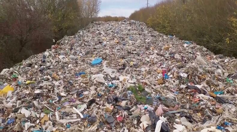 This image taken from video shows hundreds of tonnes of waste dumped in a field in the UK, near Kidlington in Oxfordshire, Nov. 16, 2025. (Sky News via AP)