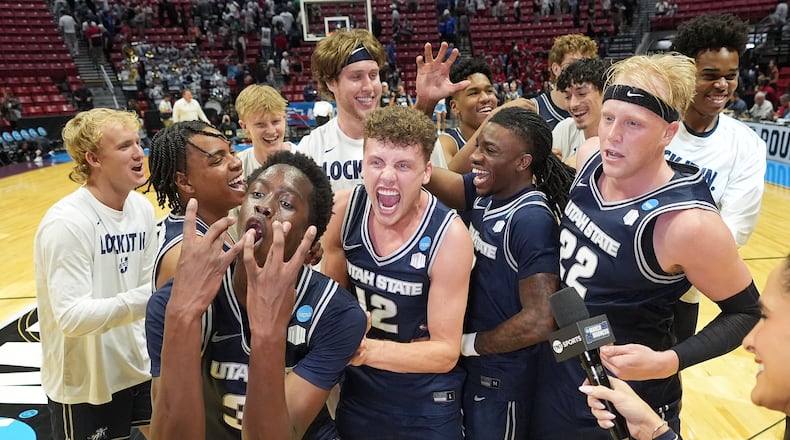 Utah State players celebrate after the first round of the NCAA college basketball tournament against Villanova, Friday, March 20, 2026, in San Diego. (AP Photo/Marcio Jose Sanchez)