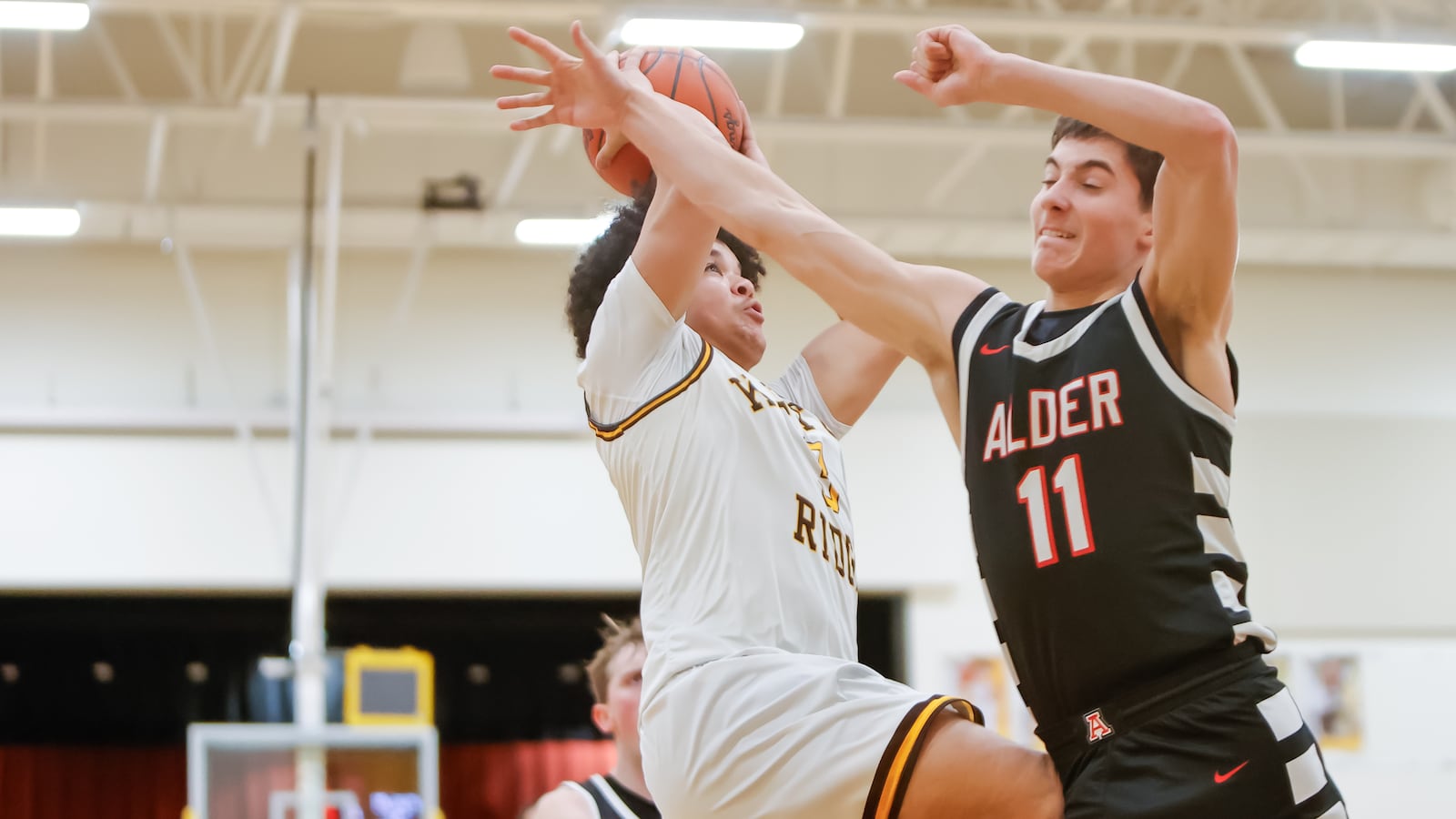 Kenton Ridge High School senior Caleb Hall drives past Jonathan Alder sophomore Danny Bentley during their game on Friday, Jan. 23, 2026 in Springfield. MICHAEL COOPER / STAFF