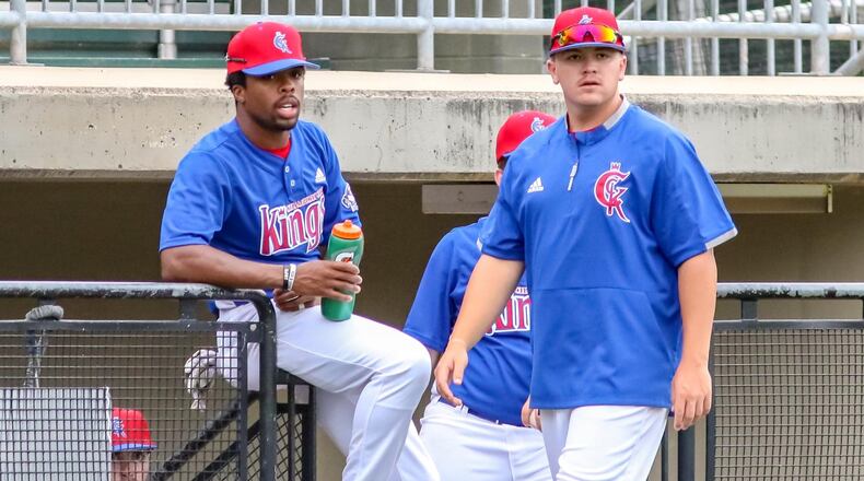 Springfield High School graduate and Champion City Kings outfielder Kawambee Moss sits at the top of the dugout with assistant coach Gavin Murphy during their 7-4 victory over the West Virginia Miners on June 5 at Carleton Davidson Stadium in Springfield. CONTRIBUTED PHOTO BY MICHAEL COOPER
