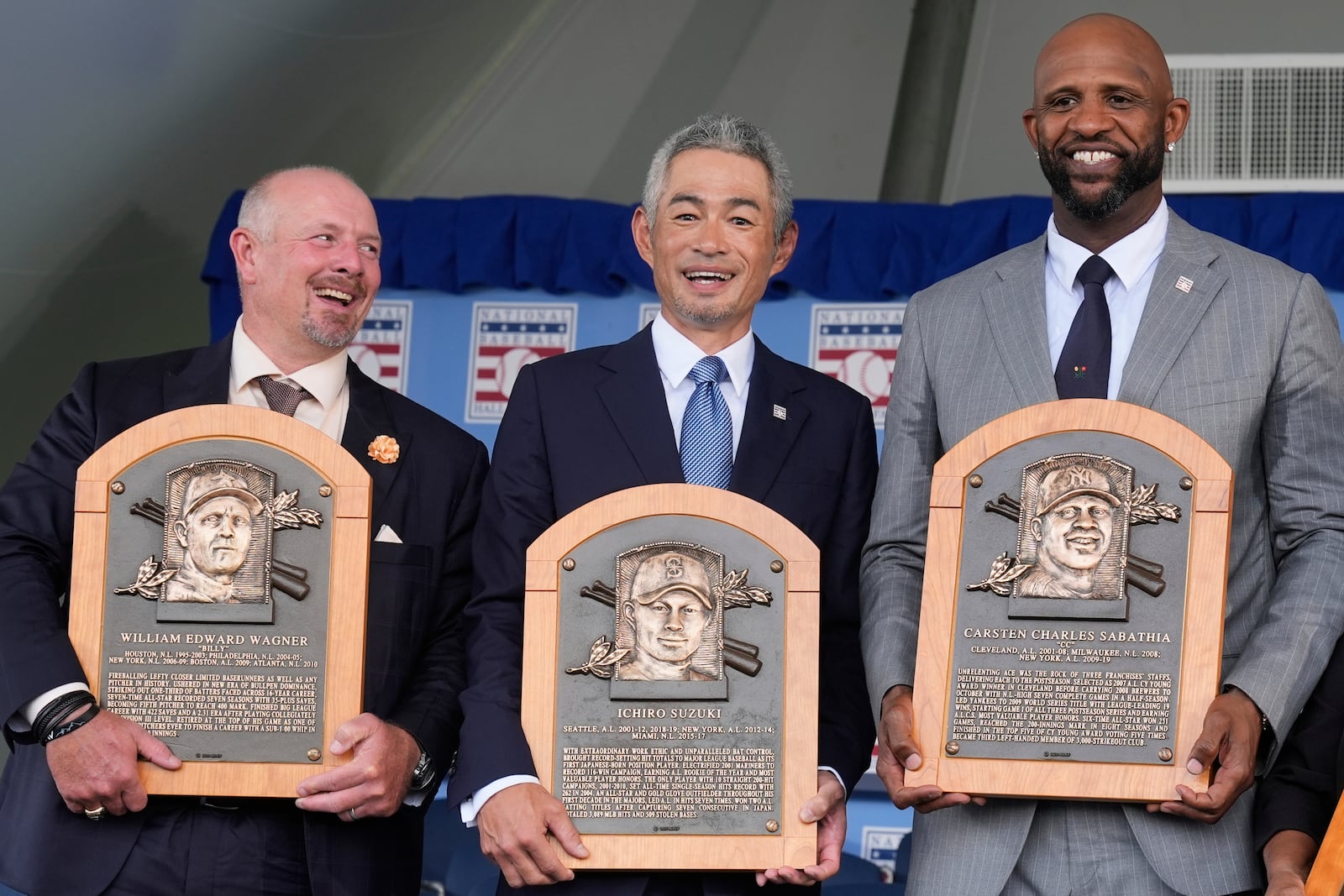 Baseball Hall of Fame inductees Billy Wagner, left, Ichiro Suzuki, center, and CC Sabathia, right, pose for a photo at the National Baseball Hall of Fame induction ceremony in Cooperstown, N.Y., Sunday, July 27, 2025. (AP Photo/Seth Wenig)