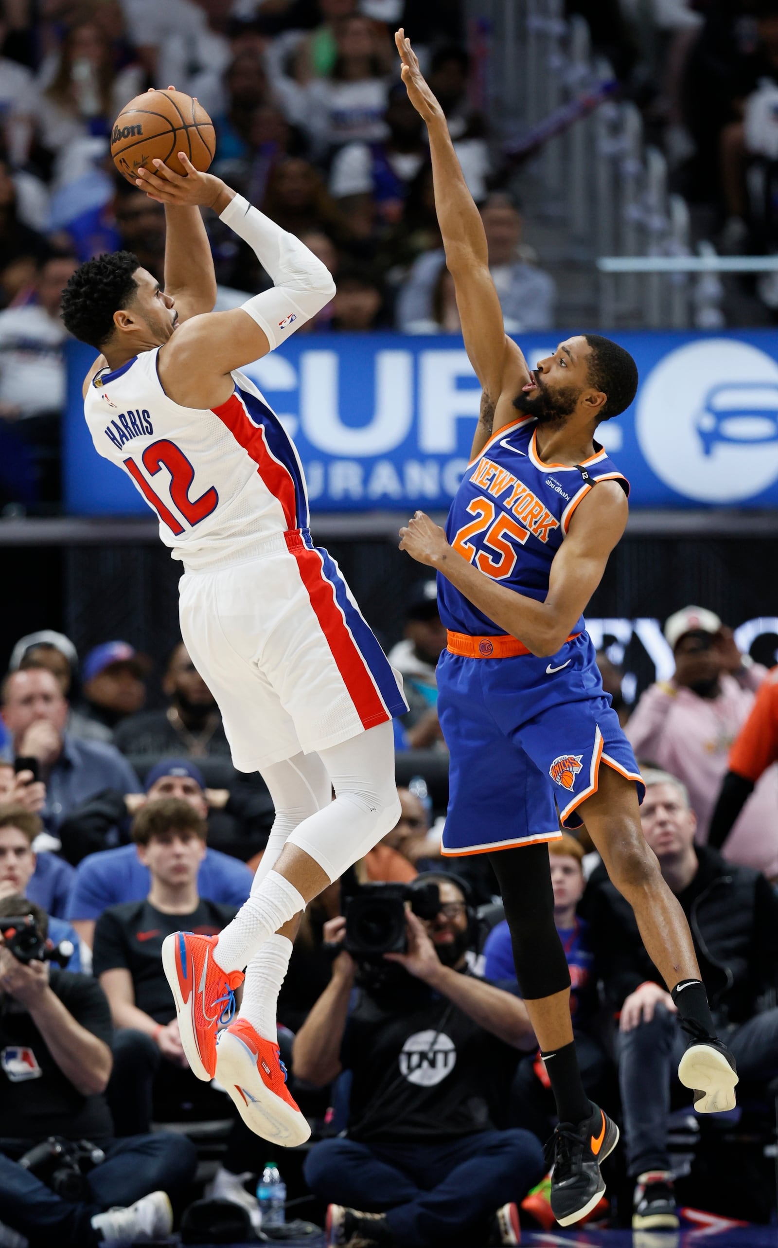 Detroit Pistons forward Tobias Harris (12) takes a jump shot against New York Knicks forward Mikal Bridges (25) during the first half of Game 6 of an NBA basketball first-round playoff series Thursday, May 1, 2025, in Detroit. (AP Photo/Duane Burleson)