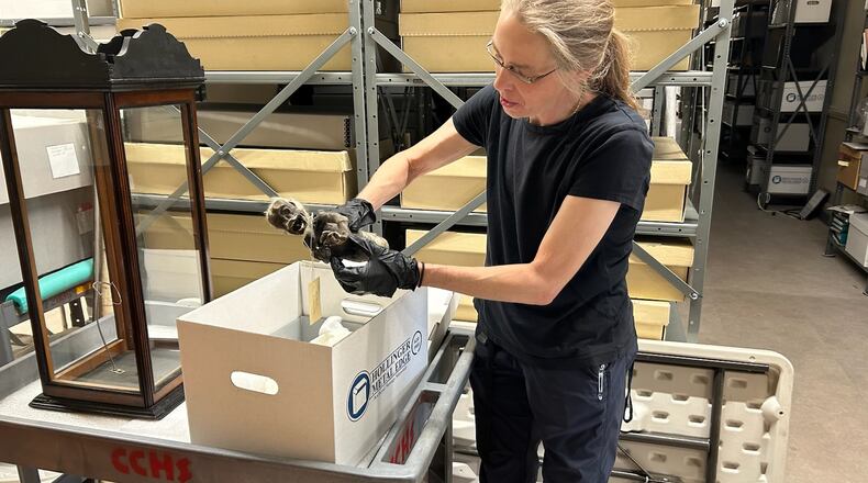 Kasey Eichensehr, senior curator at the Clark County Historical Society, holds the “Fiji Mermaid” artifact that will be taken to Northern Kentucky University on Friday afternoon to get an x-ray and CT scan to see what is it made of. JESSICA OROZCO/STAFF