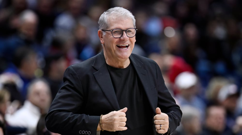 UConn head coach Geno Auriemma smiles in the first half of an NCAA college basketball game against Creighton, Wednesday, Feb. 11, 2026, in Storrs, Conn. (AP Photo/Jessica Hill)