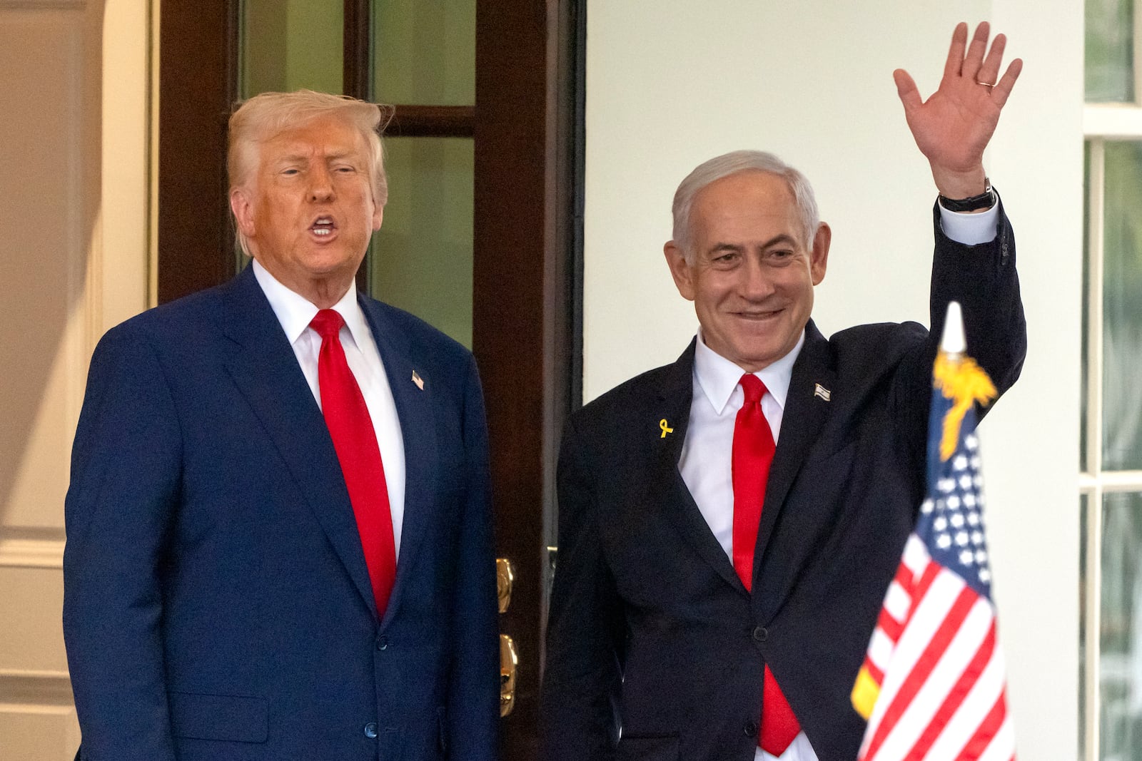President Donald Trump, left, speaks as Israel's Prime Minister Benjamin Netanyahu waves up leaving the West Wing of the White House, Monday, April 7, 2025, in Washington. (AP Photo/Mark Schiefelbein)