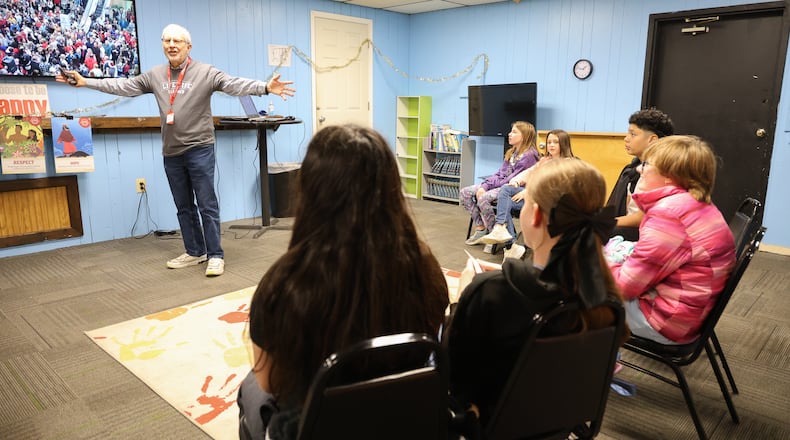 Rich Hall (top left), a LifeWise Academy teacher, talks to a group of Ruskin Elementary School students on Tuesday, Jan. 6, at a Dayton church. LifeWise, which is headquartered in Hilliard, is an organization that offers Christian education to public school students during school hours at sites near school buildings. BRYANT BILLING/STAFF