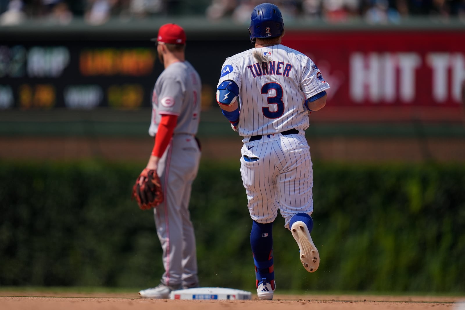Chicago Cubs' Justin Turner (3) runs the bases after hitting a double during the seventh inning of a baseball game against the Cincinnati Reds, Wednesday, Aug. 6, 2025, in Chicago. (AP Photo/Erin Hooley)