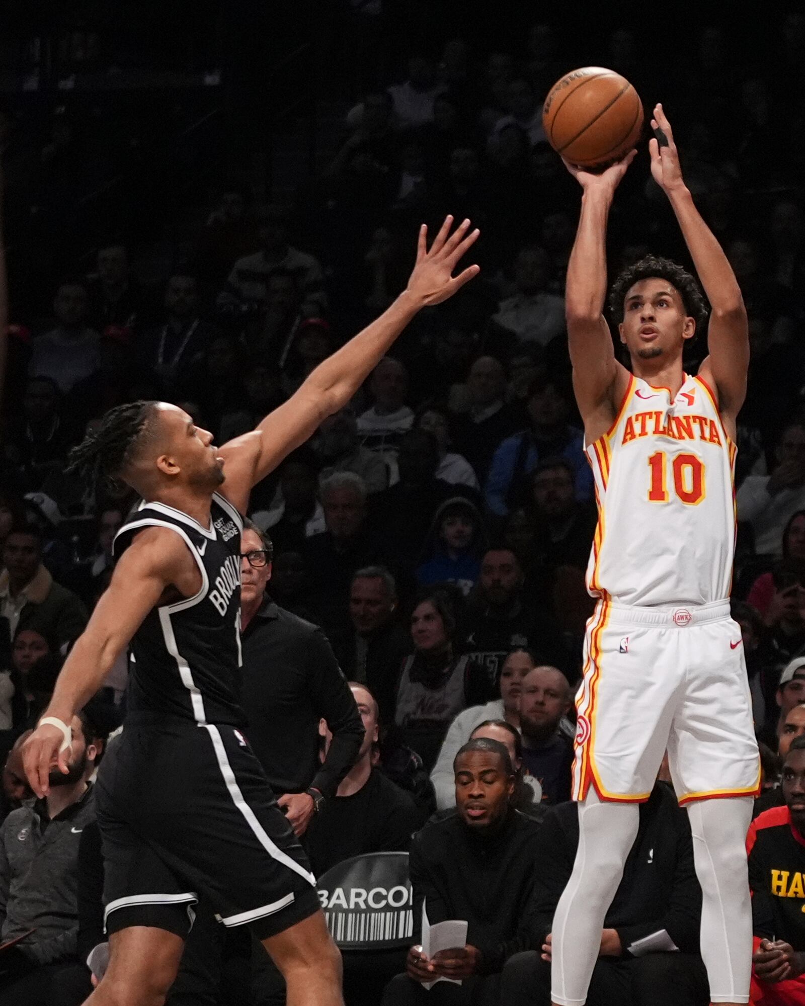 Atlanta Hawks' Zaccharie Risacher (10) shoots over Brooklyn Nets' Tosan Evbuomwan (12) during the first half of an NBA basketball game Thursday, April 10, 2025, in New York. (AP Photo/Frank Franklin II)