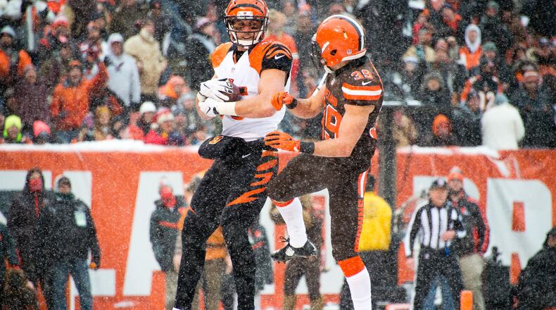 Bengals tight end Tyler Eifert catches a touchdown pass while under pressure from Browns free safety Ed Reynolds during a game on December 11, 2016 in Cleveland's FirstEnergy Stadium.