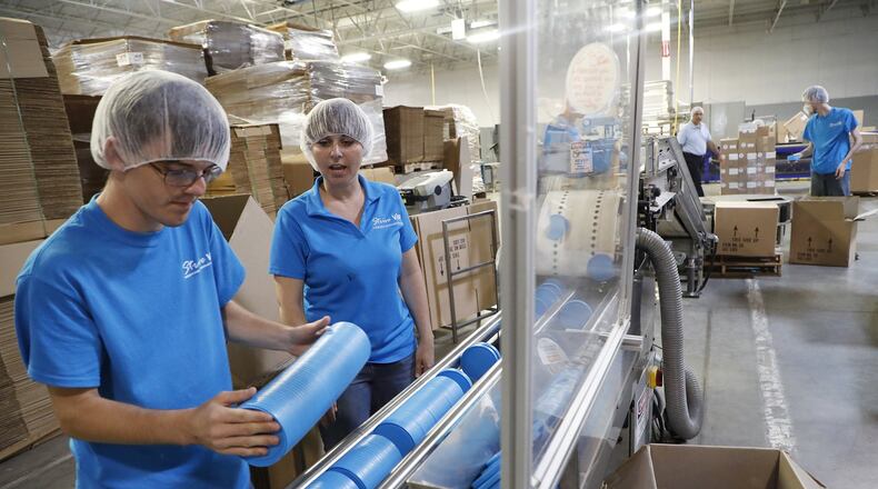 Laura Lippencott watches as William Bailey, practices packaging container lids at Tech II Monday. CRSI Strive is developing a new Vocational Internship Program (VIP) hosted by TECH II. Bill Lackey/Staff