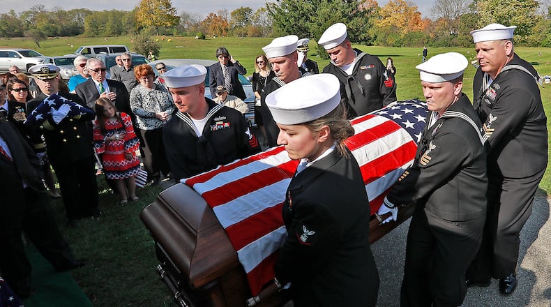 Members of a Navy honor guard carry the remains of William “Billy” Welch to the grave site at Calvary Cemetery. Welch was killed 75 years ago during the bombing of Pearl Harbor and his remains were just recently identified. Welch, who attended Catholic Central High School, was buried with full military honors Saturday. Bill Lackey was nominated for an Ohio APME award for this photo. Bill Lackey/Staff