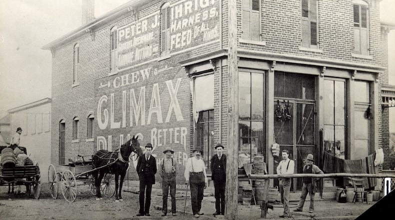 The Ihrig family came to America from Germany in 1854, eventually settling in Springfield in the 1860s. In the 1880s the family ran several stores in town, including the one here at the corner of West Main and Sigler Street, opened by Peter J. Ihrig. The store specialized in âstaple and fancy groceries, provisions, notionsâ, and harnesses. Shown standing in the center around 1890 are, from left to right, John Booser, John F. Walter, Peter Ihrig and Romaldus Schmidt (Smith). By the early 1900s all of the local Ihrigs worked for John I. Ihrig and Sons, which was located until the early 1970s across the street from this original store on West Main.