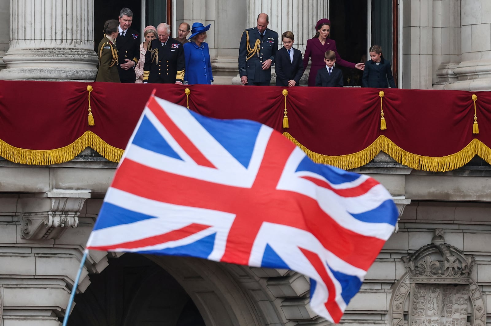 Members of the royal family on the balcony of Buckingham Palace to view the fly past featuring the Royal Air Force's Red Arrows after a military procession marking the 80th anniversary of V-E Day, in London, Monday, May 5, 2025. (Toby Melville/Pool Photo via AP)