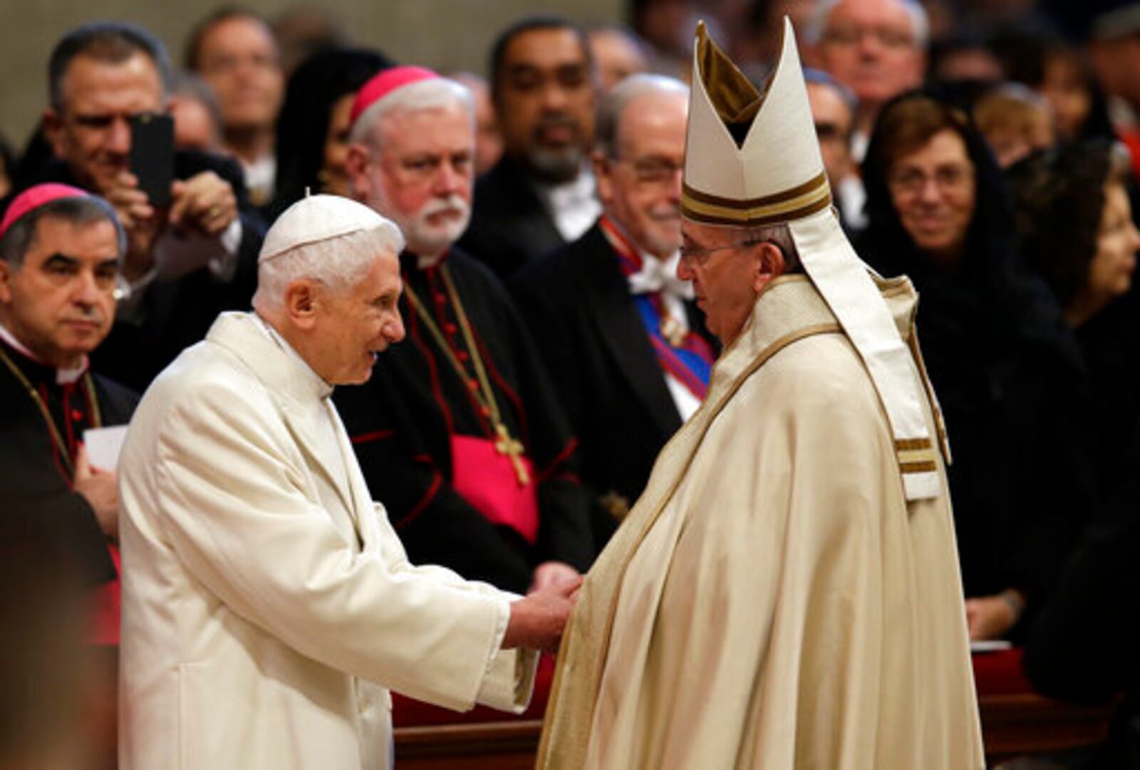FILE - Pope Emeritus Benedict XVI, left, greets Pope Francis in St. Peter's Basilica at the Vatican, Saturday, Feb. 14, 2015. (AP Photo/Andrew Medichini, file)