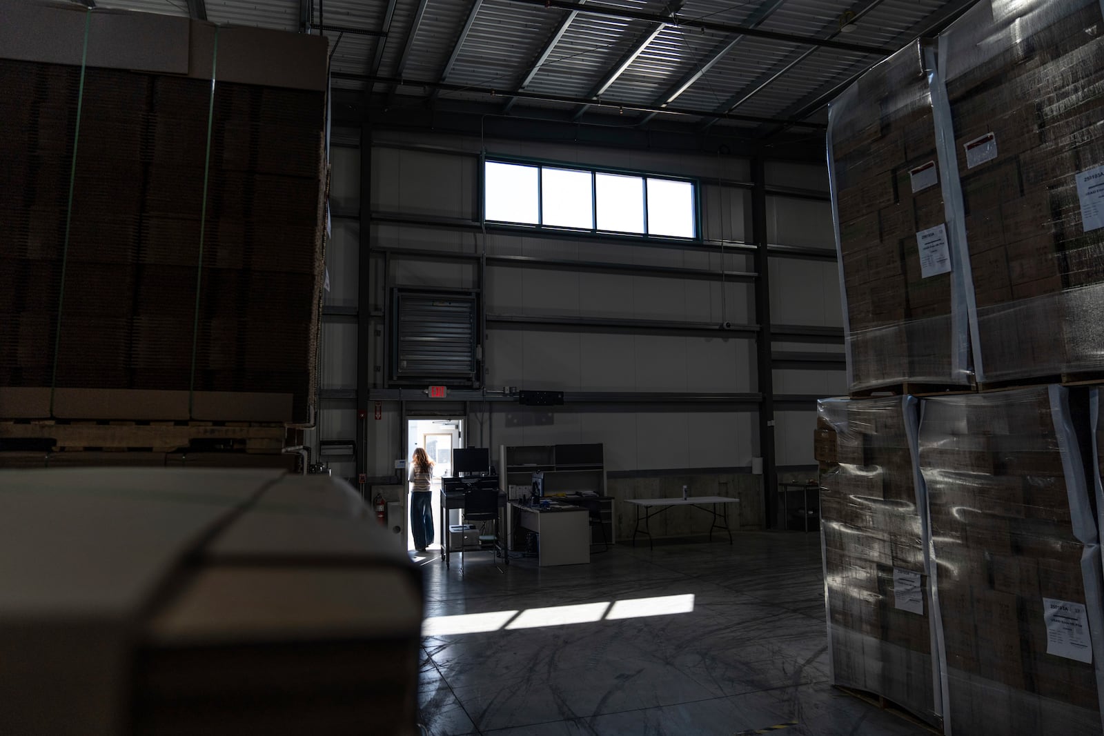 Edesia Nutrition CEO Navyn Salem leaves a warehouse storing shipping boxes of Plumpy'Nut, a nutritional lifesaving peanut paste sent to malnourished children worldwide, Friday, March 14, 2025, in North Kingstown, R.I. (AP Photo/David Goldman)