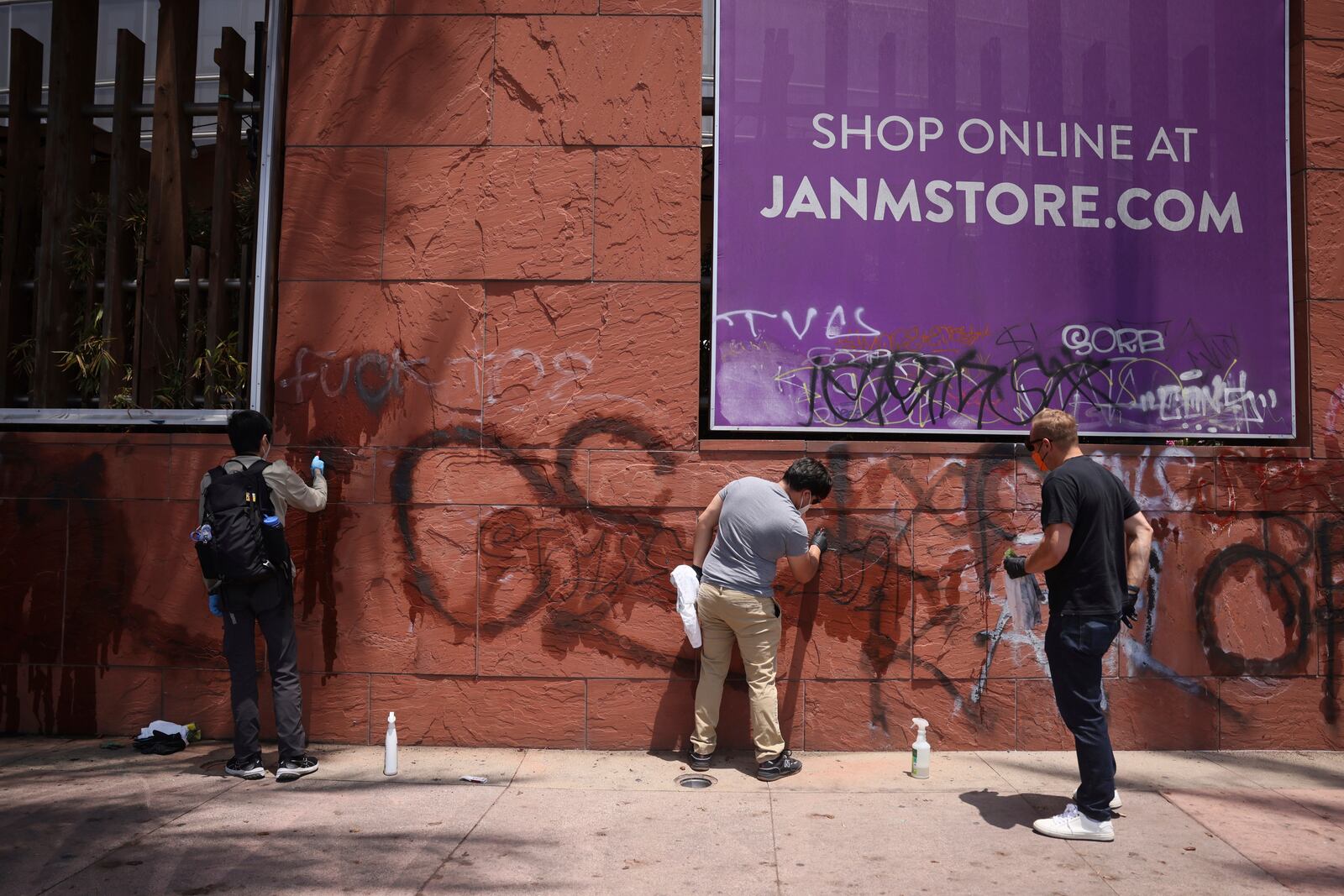 FILE - Volunteers remove graffiti from the the Japanese American Museum, Thursday, June 12, 2025, in downtown Los Angeles. (AP Photo/Etienne Laurent, File)
