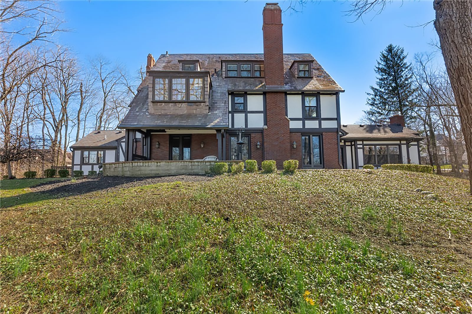 The home sits on a 1.1 acre lot and the back features a partially covered paver patio and stone steps that lead down to the basement and garage level. CONTRIBUTED