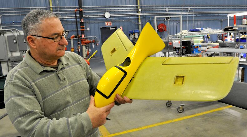 Frank Beafore, executive director of SelectTech GeoSpatial, looks over one of the small UAV's built at the company's Springfield facility.