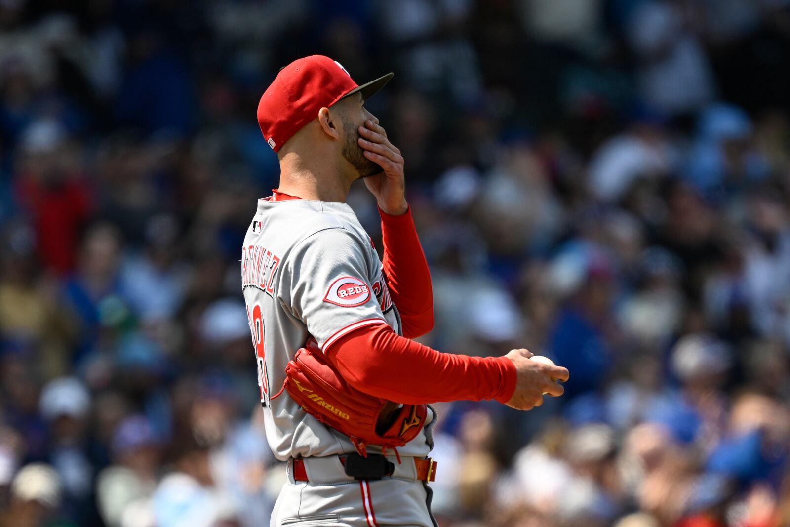 Cincinnati Reds pitcher Nick Martinez covers his mouth after Chicago Cubs' Michael Busch hit a two-run home run during the third inning of a baseball game, Sunday, June 1, 2025, in Chicago. (AP Photo/Matt Marton)
