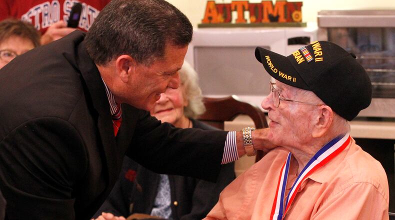 Charlie Burke, a World War II veteran and resident of Patriot Ridge Nursing Home in Fairborn, was presented with a medallion minted in honor of veterans of World War II. The Greene County Veterans Services Office and State Rep. Rick Perales, R-Beavercreek presented five World War II veterans with the medallions at a presentation at the nursing home Wednesday. The medallions were minted in honor and remembrance of veterans of WWII by the Non Commissioned Officers Association. The second annual veterans summit meeting in Greene County will be held tonight from 6-8 p.m. at 571 Ledbetter Rd. in Xenia. Representatives from veterans organizations, including the Dayton VA, will be on hand to answer veterans questions and make them aware of benefits they may not know about. LISA POWELL / STAFF