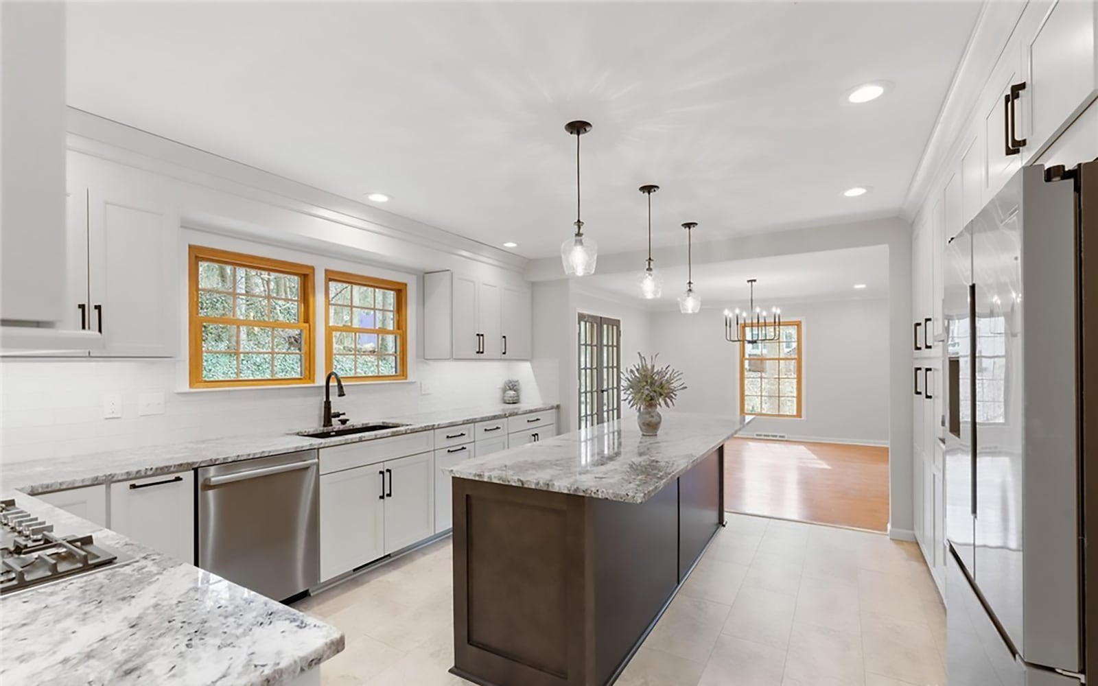 The kitchen has been updated with tile flooring, granite countertops and a tile backsplash. There is an island with pendant lights and bar seating and all new stainless appliances. CONTRIBUTED