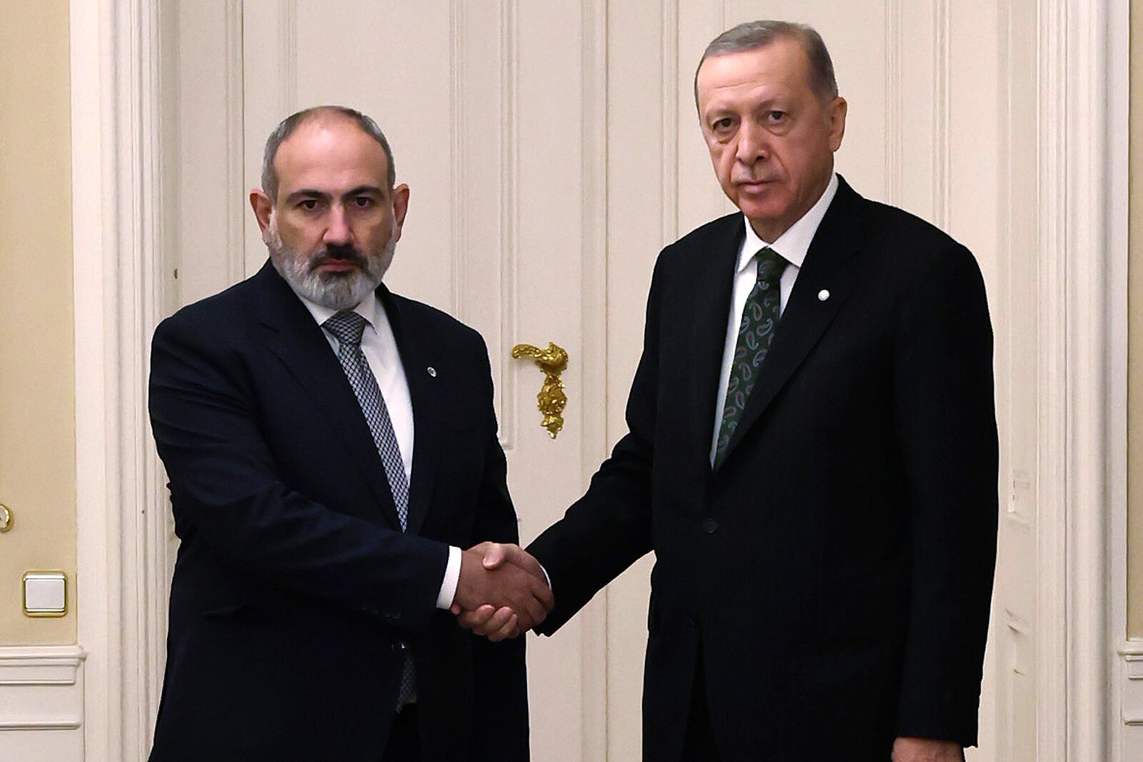 FILE - Turkey's President Recep Tayyip Erdogan, right, and Armenia's Prime Minister Nikol Pashinyan shake hands before a meeting at Prague Castle in Prague, Czech Republic, Thursday, Oct. 6, 2022. (Turkish Presidency via AP, file)