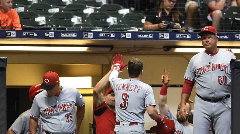 MILWAUKEE, WI - AUGUST 21:  Scooter Gennett #3 of the Cincinnati Reds is congratulated by teammates following a home run during the ninth inning of a game against the Milwaukee Brewers at Miller Park on August 21, 2018 in Milwaukee, Wisconsin.  (Photo by Stacy Revere/Getty Images)