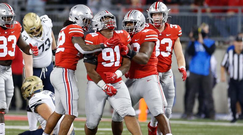 Ohio State defensive lineman Tyleik Williams (91) celebrates sacking Akron quarterback DJ Irons during the second half of an NCAA college football game Saturday, Sept. 25, 2021, in Columbus, Ohio. Ohio State beat Akron 59-7. (AP Photo/Jay LaPrete)