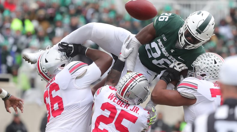 Michigan State’s Brandon Bouyer-Randle goes over Ohio State blockers defending a pass during second-half action Saturday, Nov. 10, 2018, at Spartan Stadium, in East Lansing, Mich. Ohio State won, 26-6. (Kirthmon F. Dozier/Detroit Free Press/TNS)