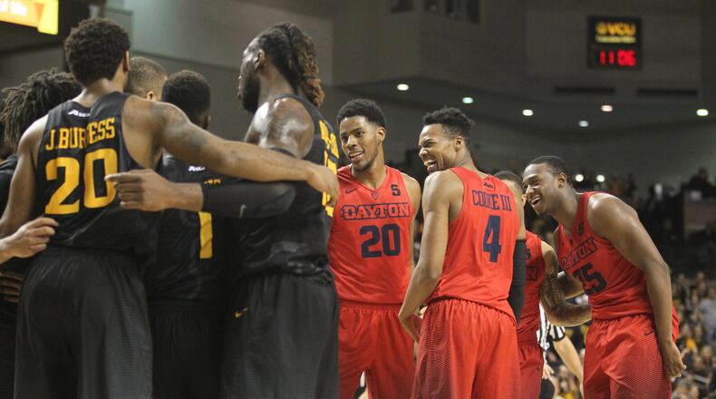 Dayton's Xeyrius Williams, Charles Cooke and Kendall Pollard share a laugh during a game against Virginia Commonwealth on Jan. 27, 2017, at the Siegel Center in Richmond, Va.