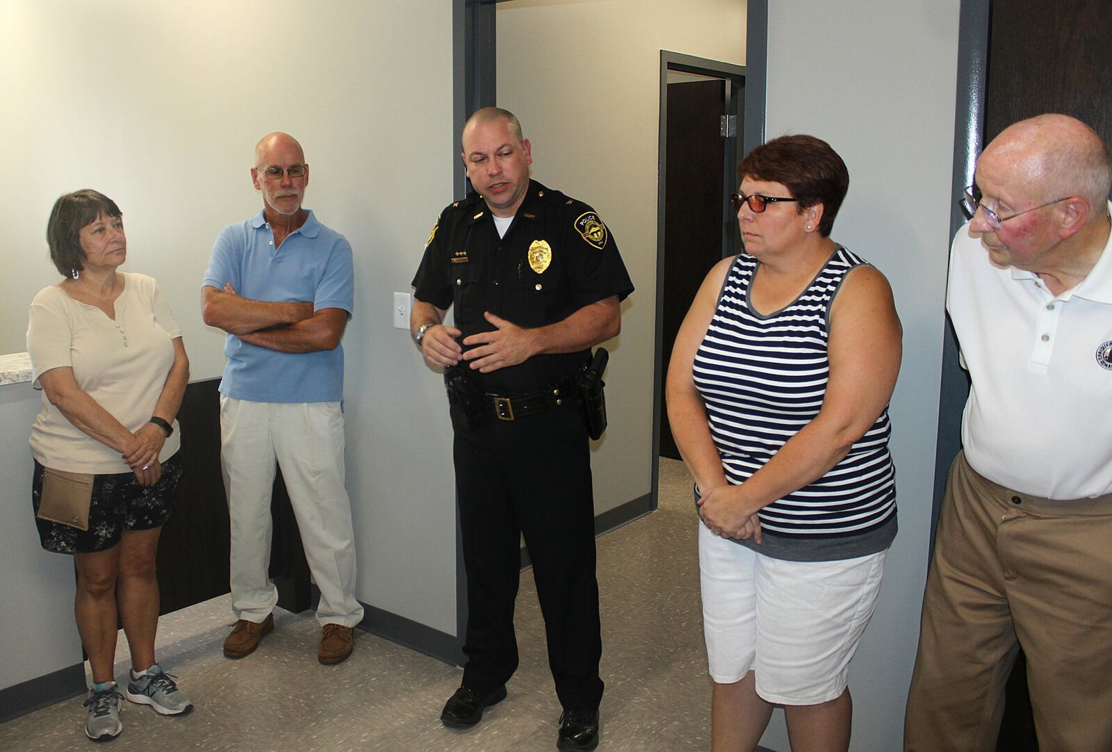 West Liberty Police Chief Shane Oelker shows community members the new police station Monday during a ribbon-cutting ceremony. 