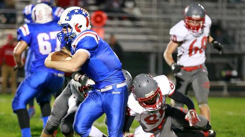 Greenevew’s Griffin Mangan breaks tackles by Southeastern’s Hayden Toops, Joe Sulfridge and Robbie Mills as he carries the ball. Bill Lackey/Staff