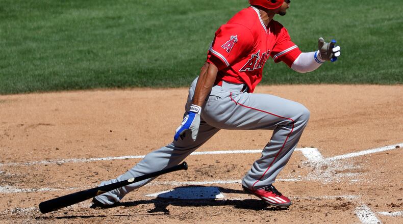 FILE - In this March 11, 2017, file photo, Los Angeles Angels’ Ben Revere follows through on an RBI base hit against the Los Angeles Dodgers during the third inning of a spring training baseball game, in Phoenix. Revere signed a minor-league deal with the Reds, Monday, Feb. 26, 2018, who need depth in the outfield and an upgrade on the bench. (AP Photo/Matt York, File)