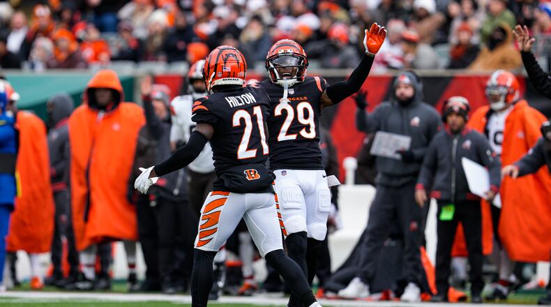 Cincinnati Bengals cornerback Mike Hilton (21) and Cam Taylor-Britt (29) celebrate a tackle for a loss against the Cleveland Browns during the first half of an NFL football game in Cincinnati, Sunday, Jan. 7, 2024. (AP Photo/Jeff Dean)
