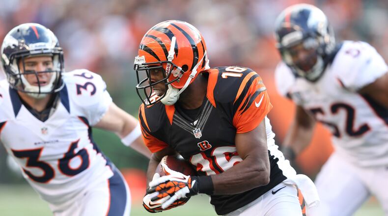 Former Bengals wide receiver Andrew Hawkins is seen here running with the ball against the Broncos at Paul Brown Stadium on November 4, 2012. He retired Tuesday shortly after signing a contract with the Patriots.