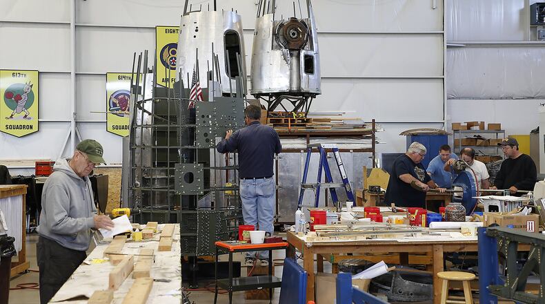 Volunteers at the Champaign Aviation Museum work on different parts of the B-17 Bomber restoration project in the museum Thursday. Bill Lackey/Staff