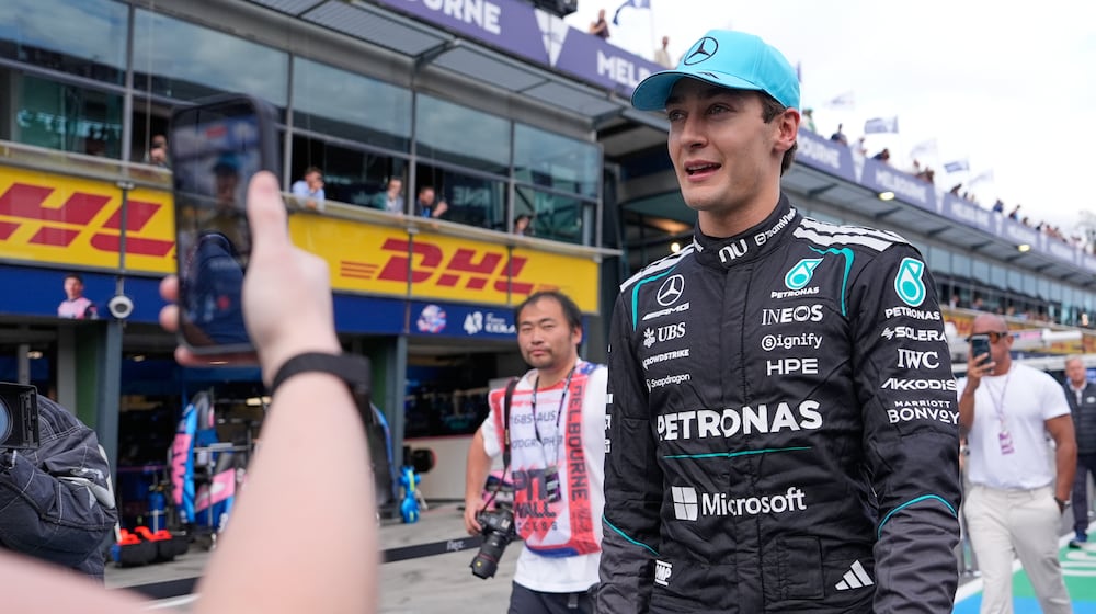 Mercedes driver George Russell of Britain walks down pit lane after winning the qualifying session for the Australian Formula One Grand Prix at Albert Park, in Melbourne, Australia, Saturday, March 7, 2026. (AP Photo/Asanka Brendon Ratnayake)