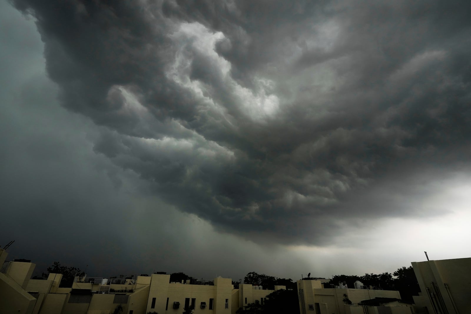 FILE - Monsoon clouds gather over New Delhi's skyline, India, June 28, 2025. (AP Photo/Manish Swarup, File)