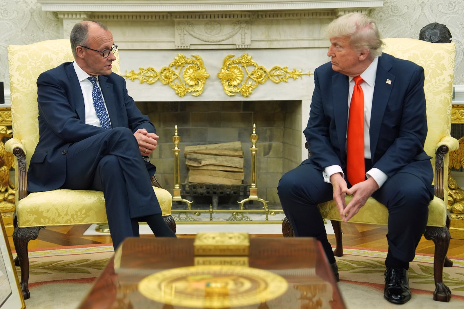 President Donald Trump, right, listens during a meeting with Germany's Chancellor Friedrich Merz in the Oval Office of the White House, Thursday, June 5, 2025, in Washington. (AP Photo/Evan Vucci)