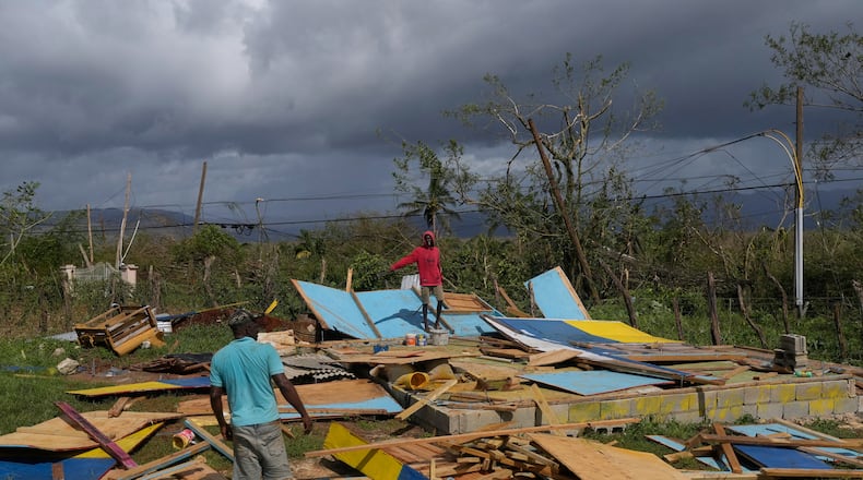 Residents stand on the wreckage of a house destroyed by Hurricane Melissa in Santa Cruz, Jamaica, Wednesday, Oct. 29, 2025. (AP Photo/Matias Delacroix)