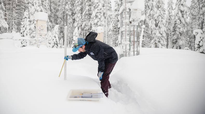 FILE - Dr. Gabe Lewis, a research scientist, measures snow depth and mass to calculate density and snow water equivalent at Central Sierra Snow Lab in Soda Springs, Calif. on Monday, Jan. 5, 2026. (Brontë Wittpenn /San Francisco Chronicle via AP, File)