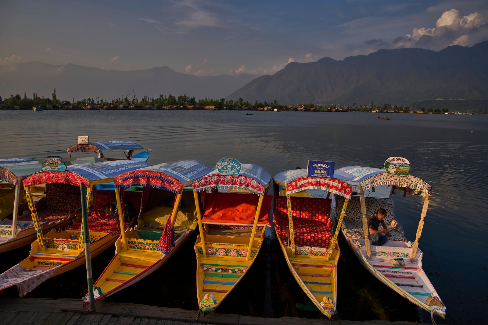 A Kashmiri man watches the news on the ceasefire between India and Pakistan as he sits inside his a shikara, or traditional boat on Dal Lake in Srinagar, in Indian controlled Kashmir, Saturday, May 10, 2025.(AP Photo/Dar Yasin)