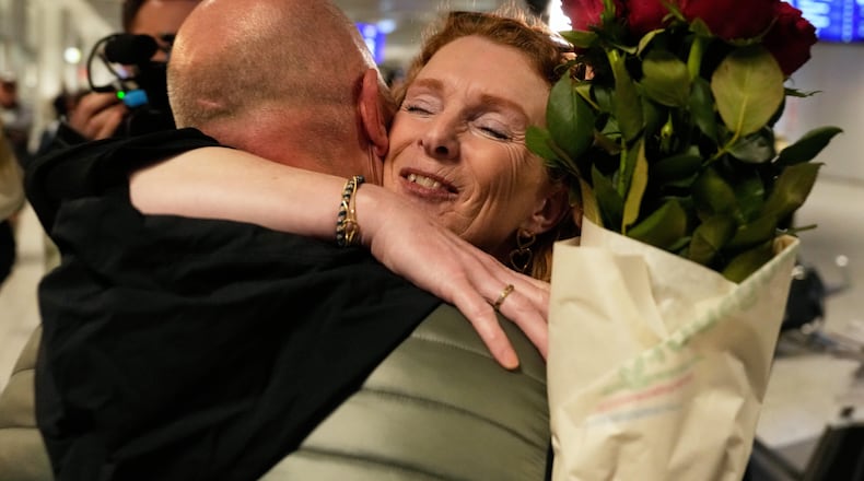 People arrive at the International Airport in Frankfurt, Germany, after being evacuated from Dubai on a commercial flight, Tuesday, March 3, 2026. (AP Photo/Michael Probst)