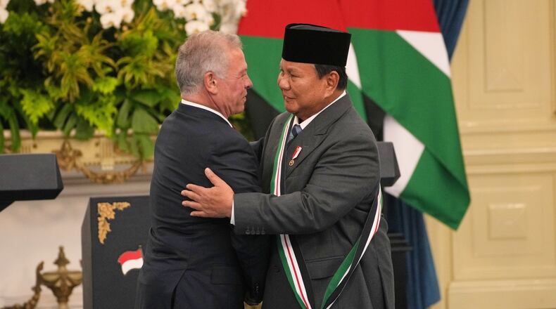 Jordanian King Abdullah II, left, hugs Indonesian President Prabowo Subianto after decorating him with the Order of the Bejewelled Grand Cordon of Al Nahda or the Supreme Order of the Renaissance, one of Jordan's high honors, during their meeting at Merdeka Palace in Jakarta, Indonesia, Friday, Nov. 14, 2025. (AP Photo/Achmad Ibrahim)