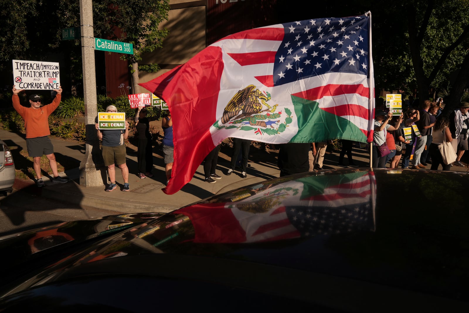 Residents gather during a community vigil on Monday, June 30, 2025, to stand in solidarity with an immigrant family after ICE agents detained Rosalina Luna Vargas on Saturday, June 28, in front of her children, in Pasadena, Calif. (AP Photo/Damian Dovarganes)